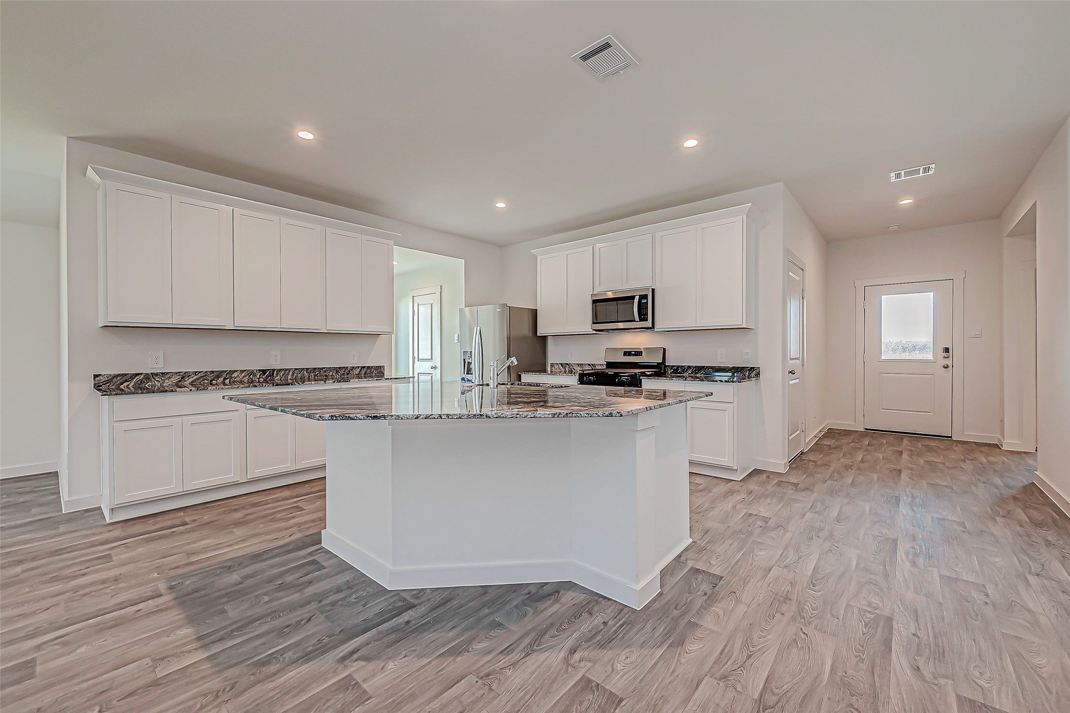 6108 Ryon Falls Drive Rosenberg, TX 77469 - Photo 16 of 39 a kitchen with granite countertop white cabinets and appliances