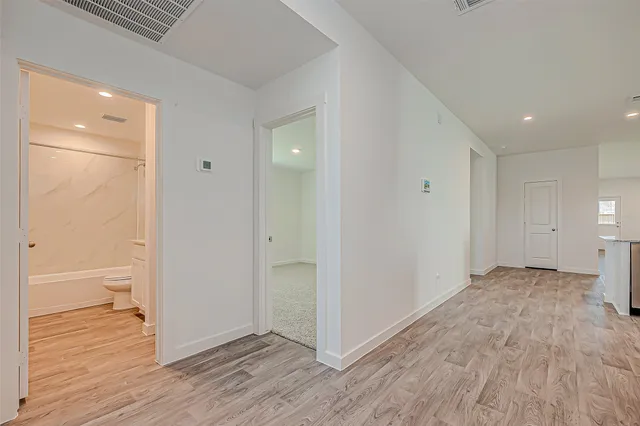 a view of hallway with wooden floor