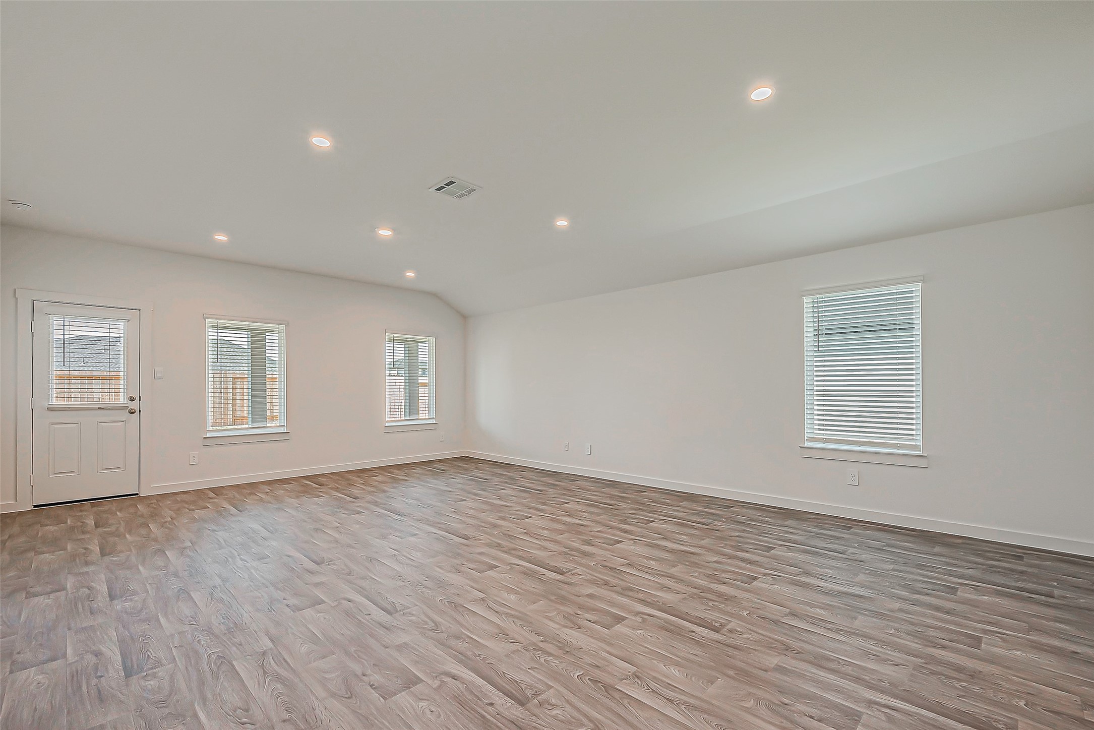 6108 Ryon Falls Drive Rosenberg, TX 77469 - Photo 8 of 39 a view of an empty room with wooden floor and a window