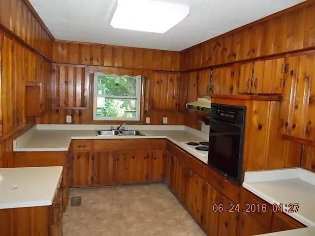 522 Bennett Hill Road Red Boiling Springs, TN 37150 - Photo 2 of 23 a kitchen with stainless steel appliances granite countertop a sink dishwasher stove and refrigerator with wooden floor