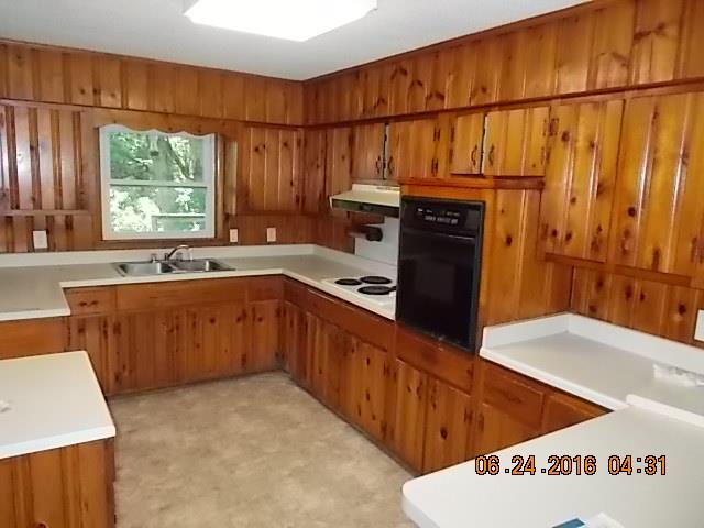 522 Bennett Hill Road Red Boiling Springs, TN 37150 - Photo 14 of 23 a kitchen with stainless steel appliances a sink a stove a refrigerator cabinets and a window