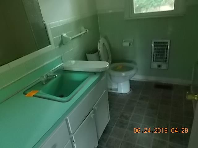 522 Bennett Hill Road Red Boiling Springs, TN 37150 - Photo 18 of 23 a bathroom with a toilet sink and green walls