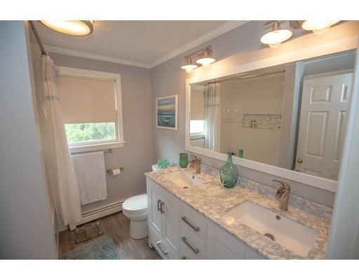 6 North Martin Road Amesbury, MA 01913 - Photo 22 of 29 a bathroom with a granite countertop sink a toilet a mirror and a window