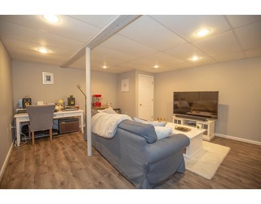 6 North Martin Road Amesbury, MA 01913 - Photo 23 of 29 a living room with furniture and a flat screen tv