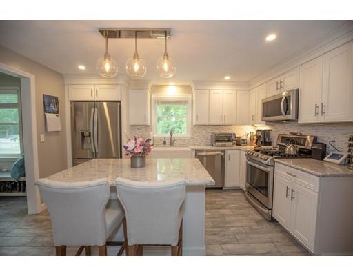 6 North Martin Road Amesbury, MA 01913 - Photo 4 of 29 a kitchen with stainless steel appliances granite countertop a sink a stove a refrigerator a microwave oven with white cabinets