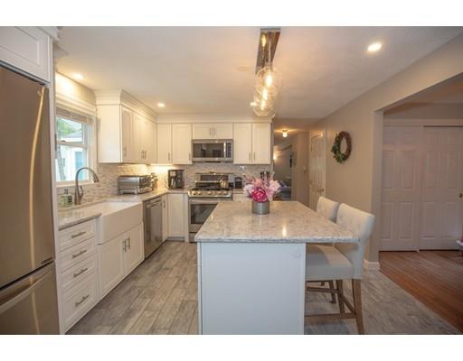 6 North Martin Road Amesbury, MA 01913 - Photo 5 of 29 a kitchen with kitchen island granite countertop a sink cabinets and stainless steel appliances