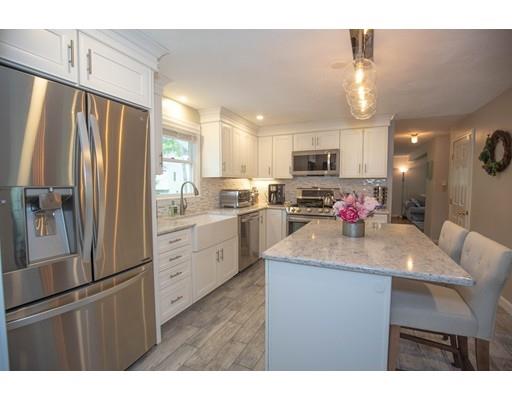 6 North Martin Road Amesbury, MA 01913 - Photo 6 of 29 a kitchen with kitchen island a refrigerator stove microwave and cabinets