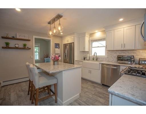 6 North Martin Road Amesbury, MA 01913 - Photo 8 of 29 a kitchen with stainless steel appliances granite countertop a sink stove and refrigerator