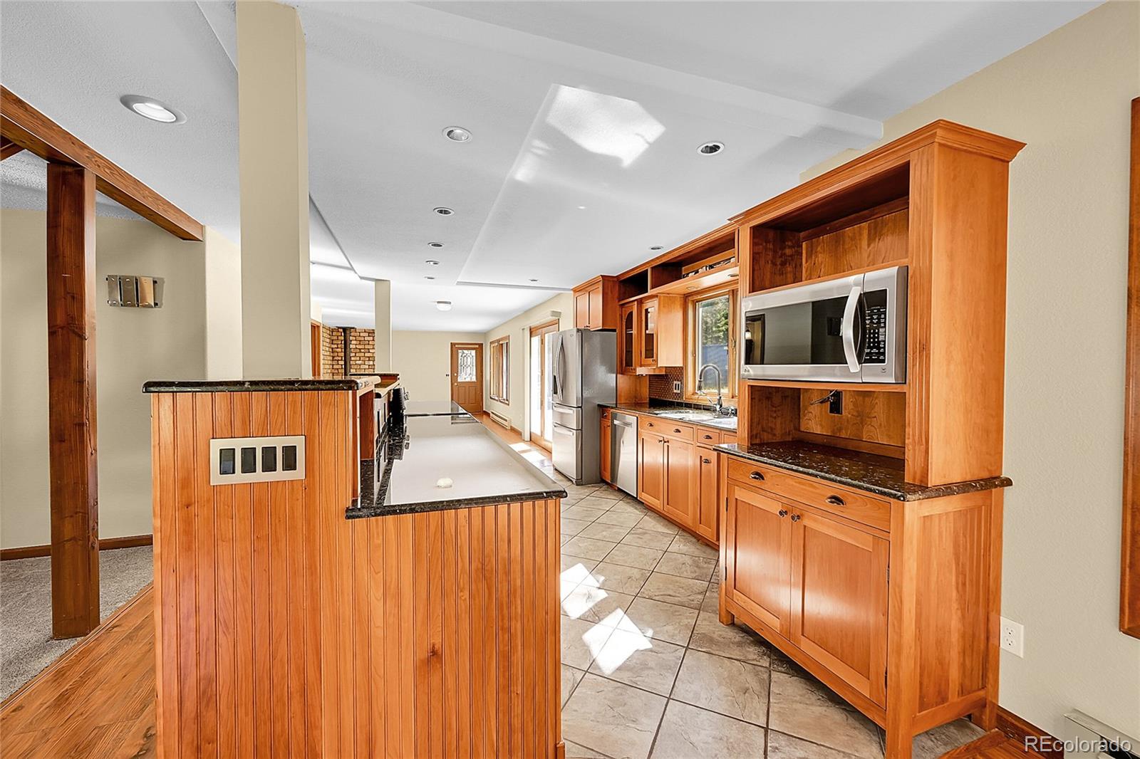 348 Nova Road Pine, CO 80470 - Photo 11 of 50 a kitchen with stainless steel appliances granite countertop a refrigerator and a stove