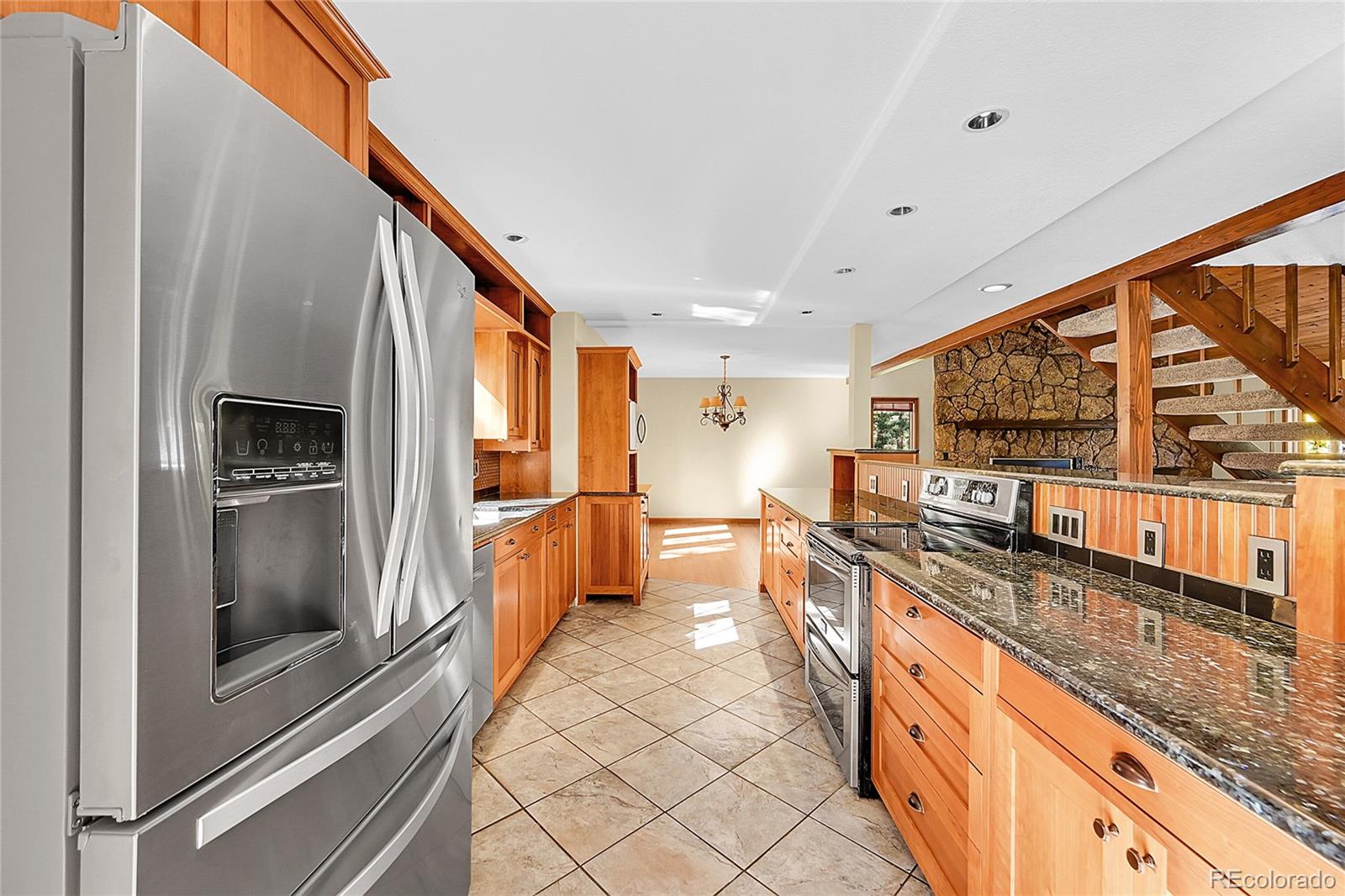 348 Nova Road Pine, CO 80470 - Photo 12 of 50 a large kitchen with stainless steel appliances granite countertop a large counter top and a stove