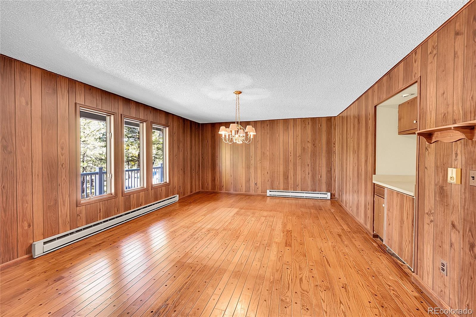 348 Nova Road Pine, CO 80470 - Photo 21 of 50 a view of an empty room with a window and wooden floor