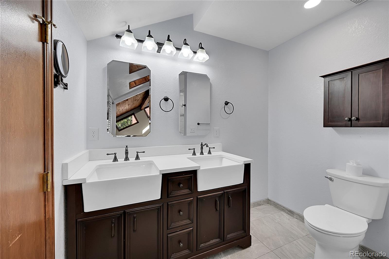 348 Nova Road Pine, CO 80470 - Photo 27 of 50 a bathroom with a toilet sink and mirror