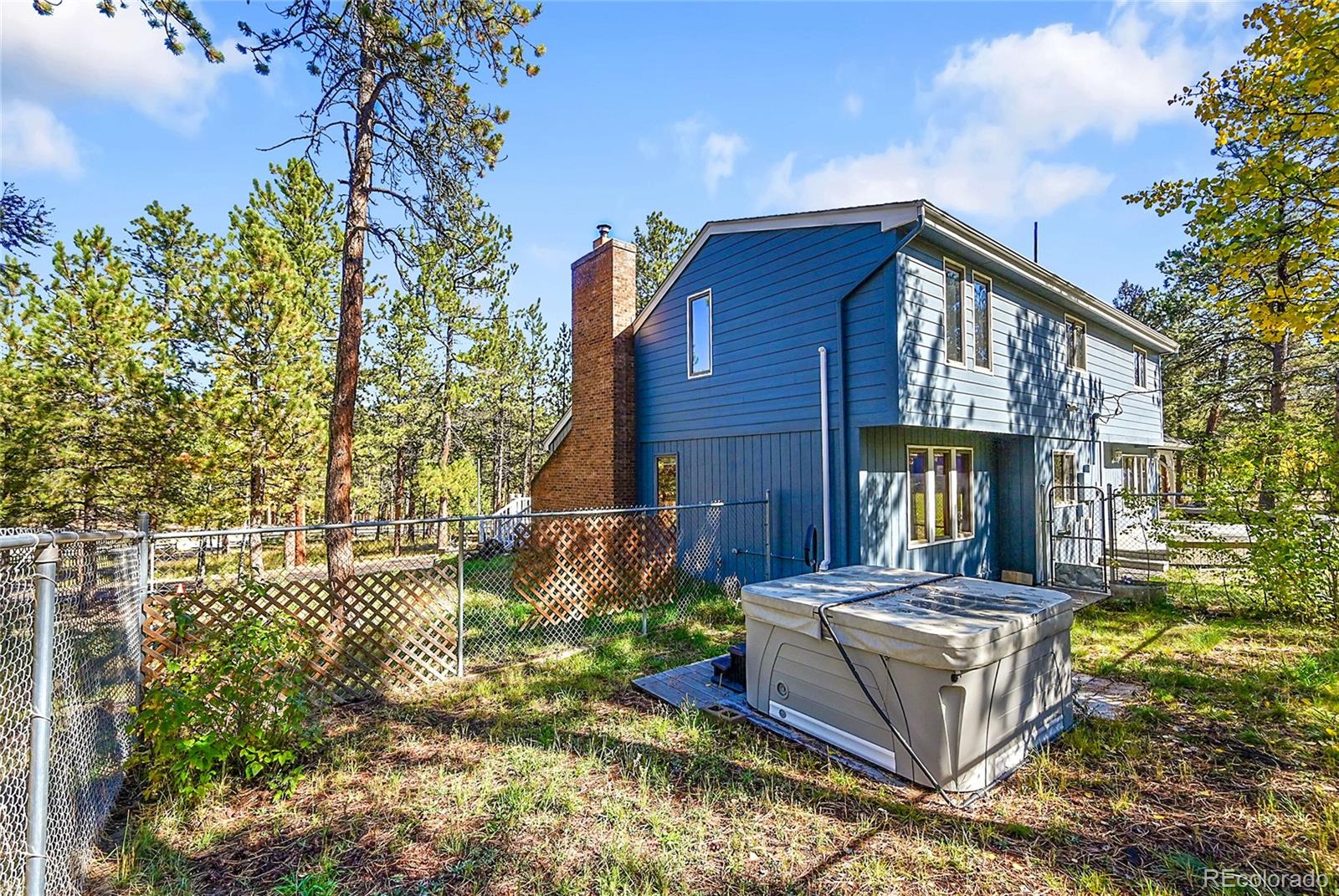 348 Nova Road Pine, CO 80470 - Photo 35 of 50 a front view of a house with garden