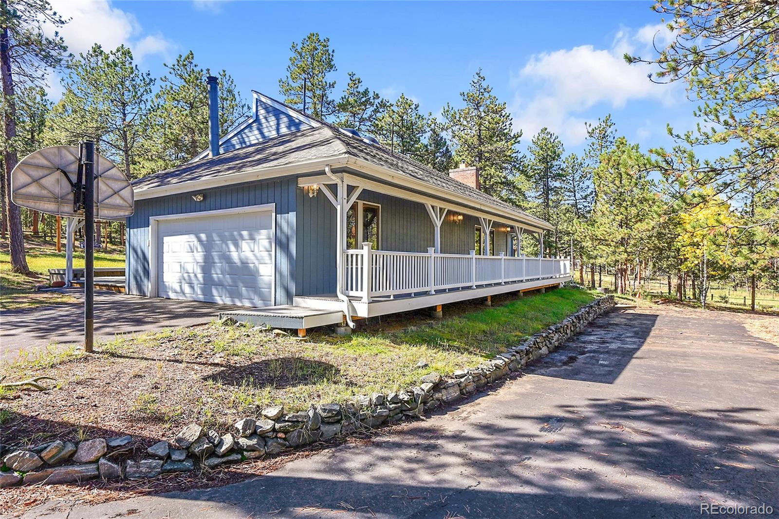 348 Nova Road Pine, CO 80470 - Photo 4 of 50 a view of a house with a small yard and wooden fence