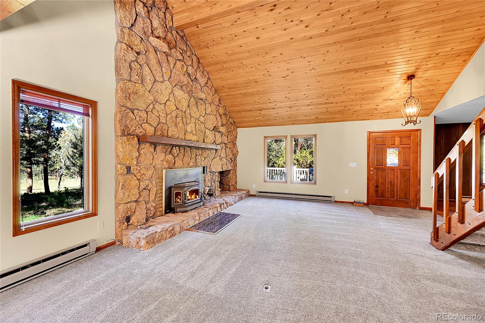 348 Nova Road Pine, CO 80470 - Photo 6 of 50 an empty room with windows and fireplace