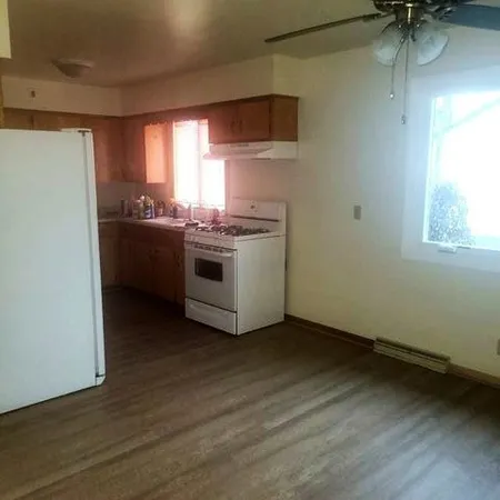 a kitchen with a stove and a refrigerator