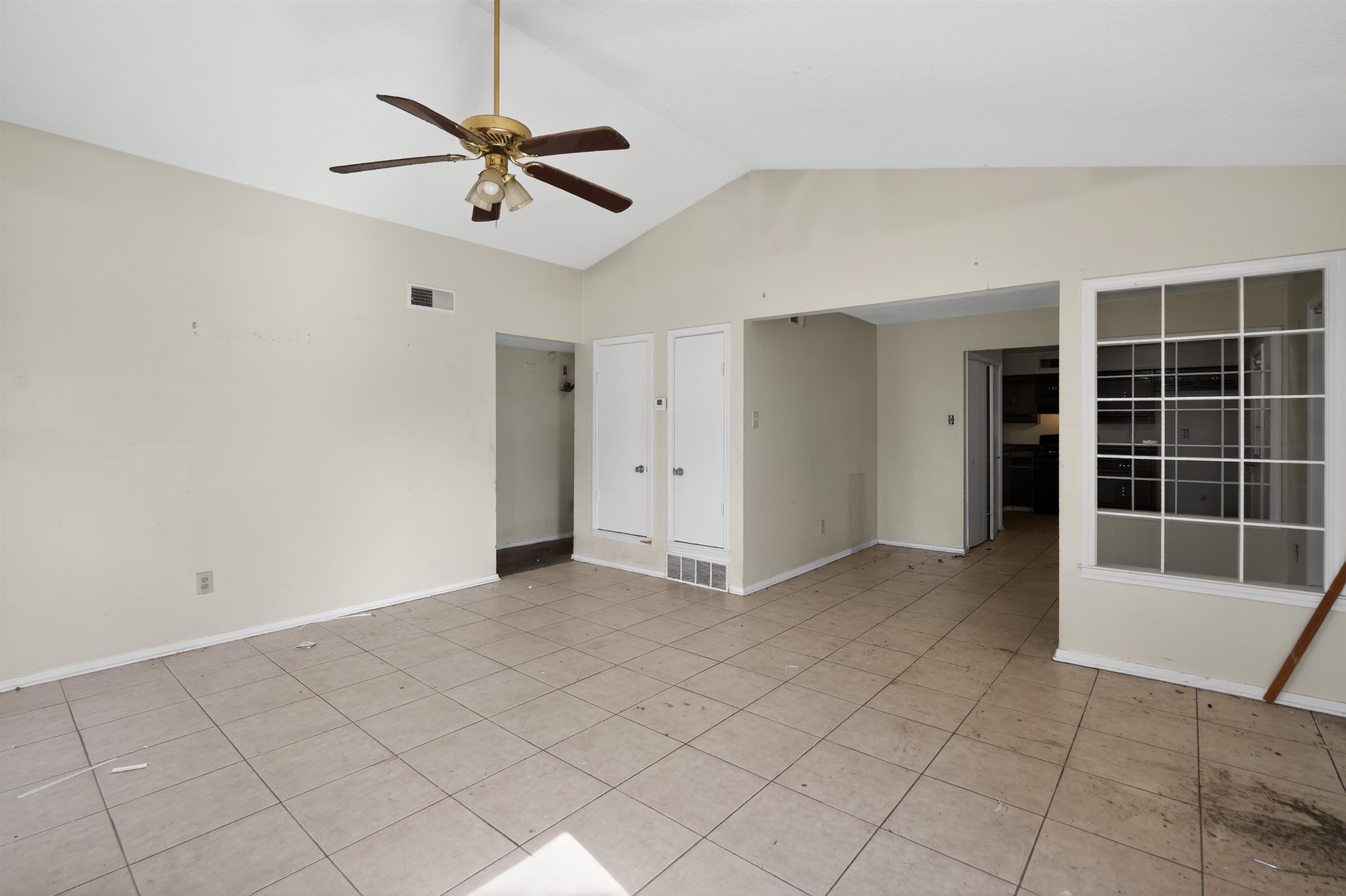 3372 Spring Shadow Drive Memphis, TN 38118 - Photo 13 of 35 Spacious room featuring vaulted ceilings, a ceiling fan with integrated lighting, and tile flooring
