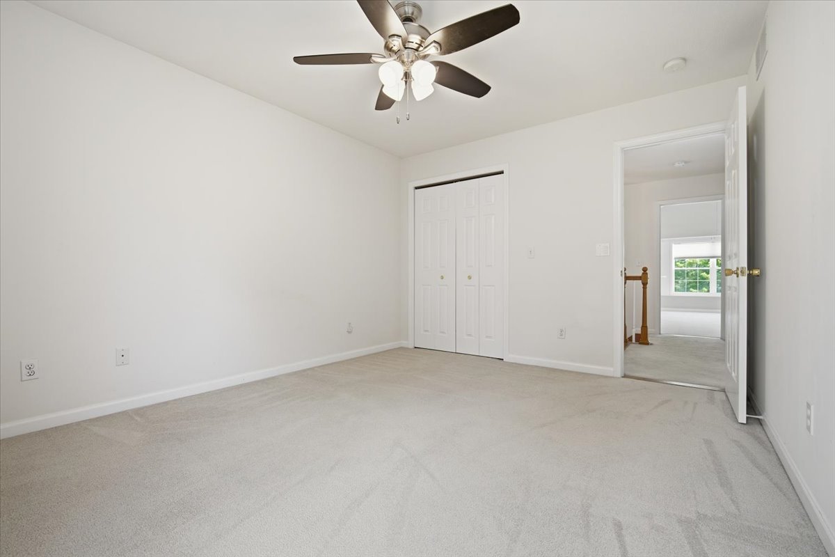 311 Old Farm Road Bloomington, IL 61704 - Photo 22 of 34 an empty room with chandelier fan
