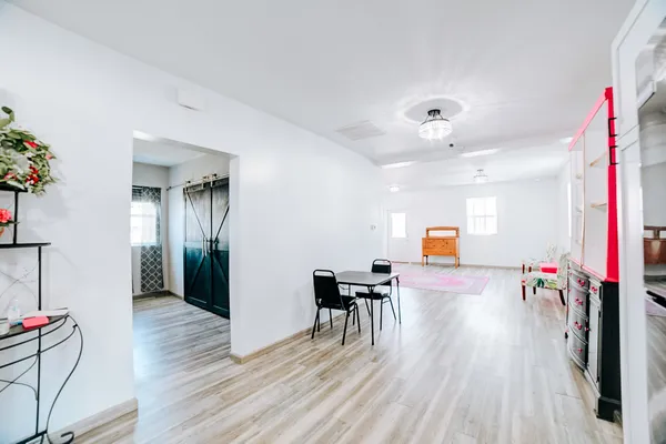 a view of a livingroom with furniture wooden floor and a chandelier