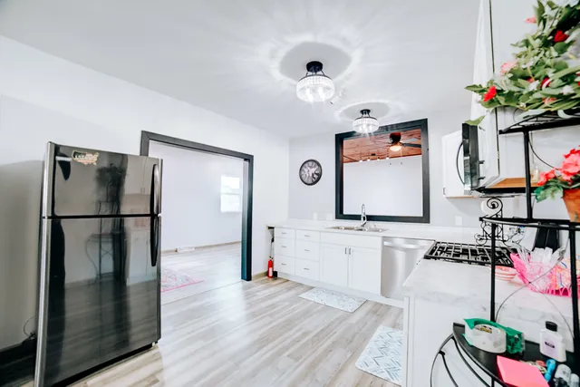 a kitchen with stainless steel appliances granite countertop a refrigerator and a stove top oven
