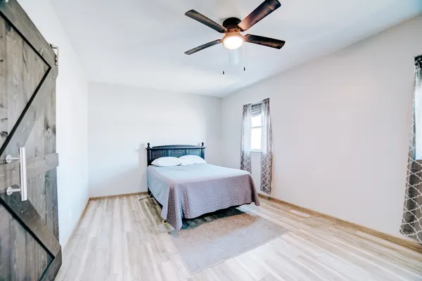 a bedroom with a large bed and a chandelier