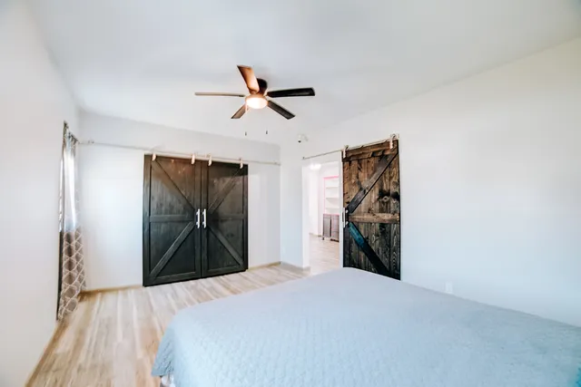 a bedroom with a bed and a chandelier