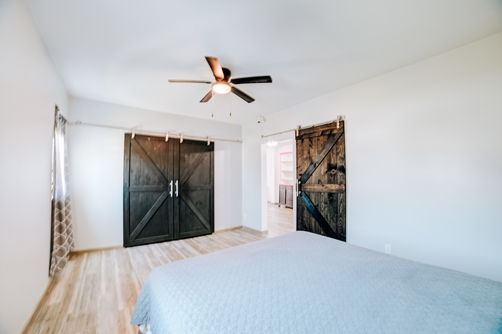 100 East Lyle Street Milford, IL 60953 - Photo 23 of 37 a bedroom with a bed and a chandelier