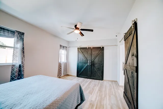 a bedroom with a bed and a chandelier