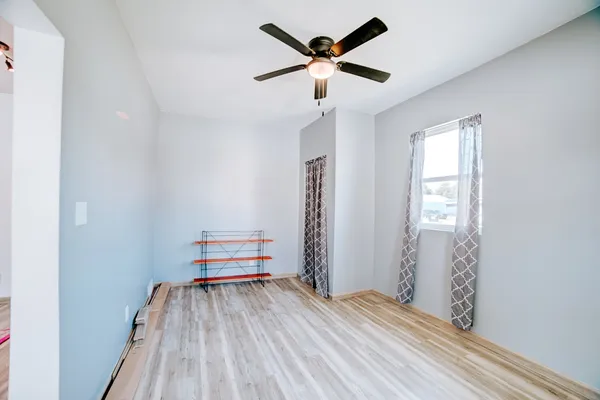 a view of empty room with wooden floor