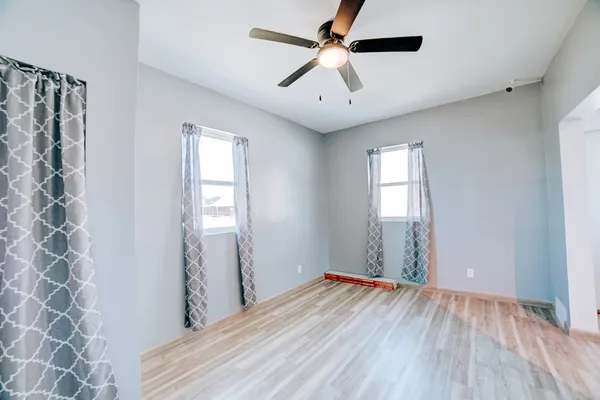 wooden floor in an empty room with a window