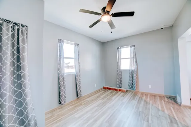 wooden floor in an empty room with a window
