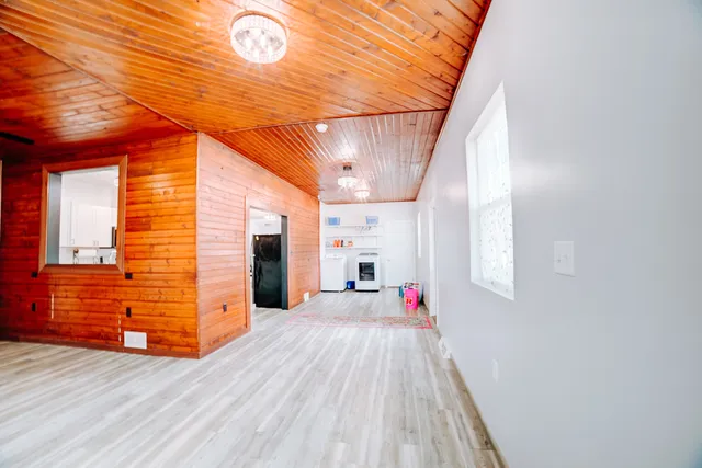 a view of a room with wooden walls and stairs