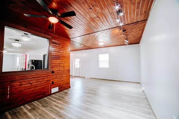 a view of a room with wooden floor and brick walls