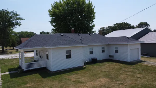 a view of a house with a backyard