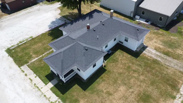 an aerial view of a house with a yard