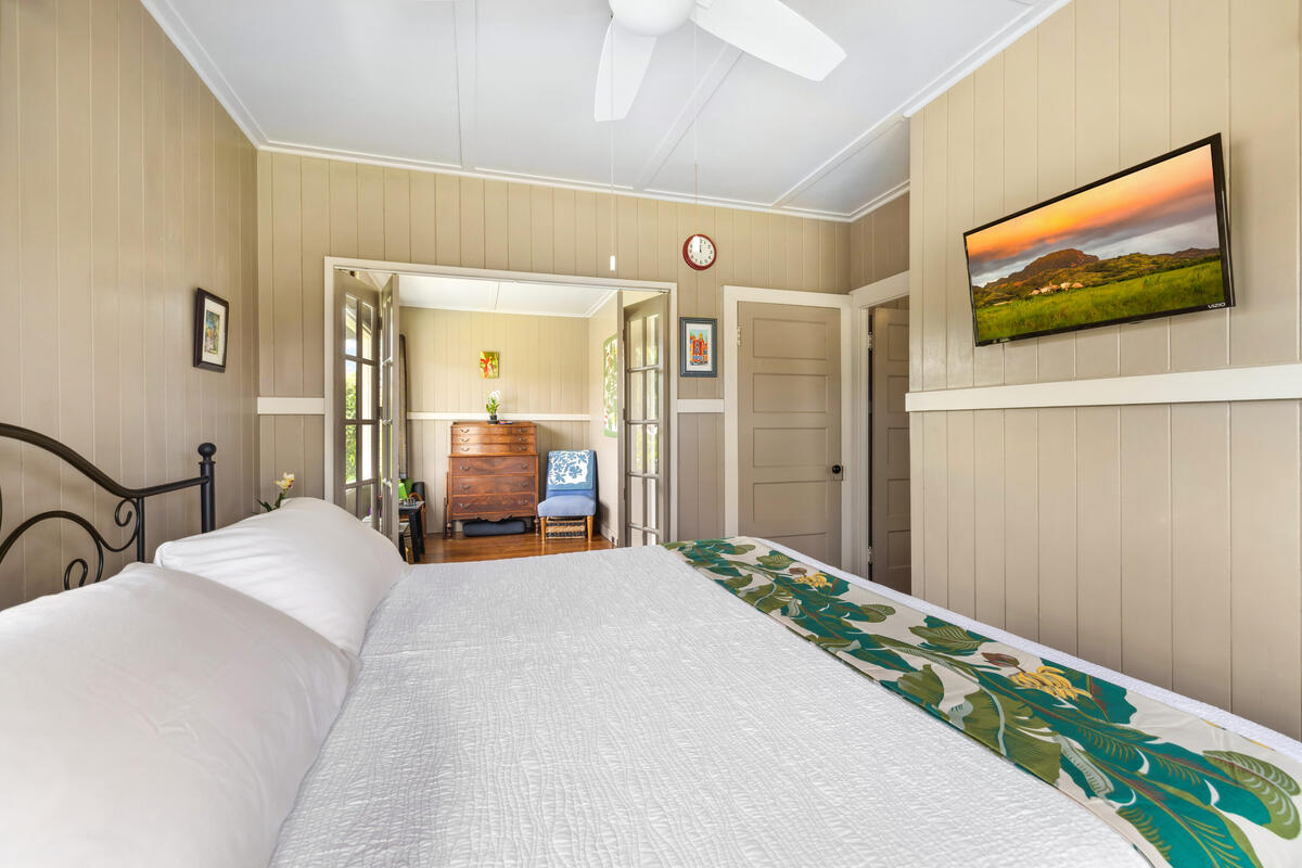 3895 Koloa Road, Unit 1 Koloa, HI 96756 - Photo 11 of 30 a bedroom with a bed and a flat screen tv