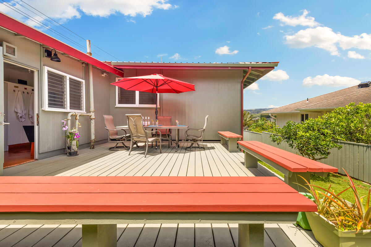 3895 Koloa Road, Unit 1 Koloa, HI 96756 - Photo 27 of 30 a view of a patio with a table and chairs under an umbrella