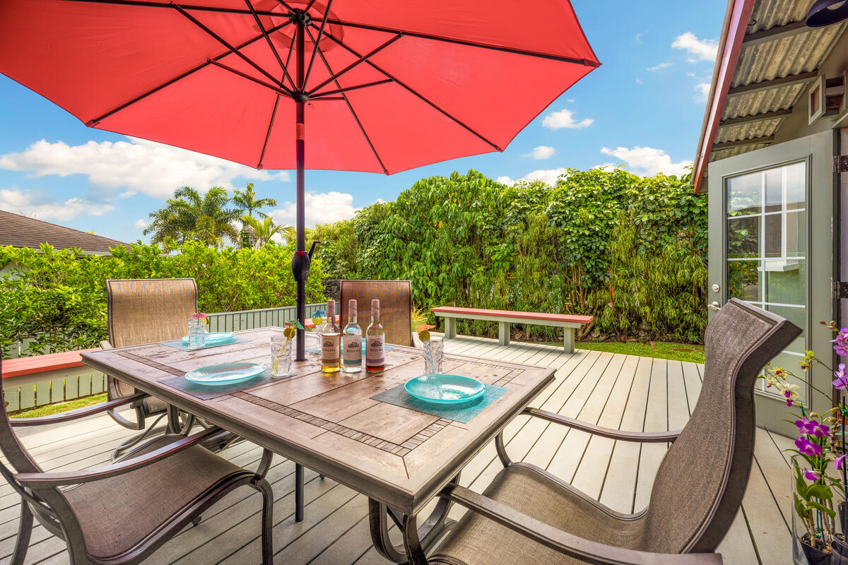 3895 Koloa Road, Unit 1 Koloa, HI 96756 - Photo 7 of 30 a view of a patio with a table and chairs under an umbrella