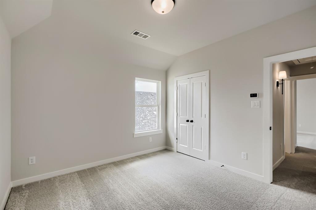 4414 Windy Point Road Oak Point, TX 75068 - Photo 21 of 27 an empty room with windows and closet
