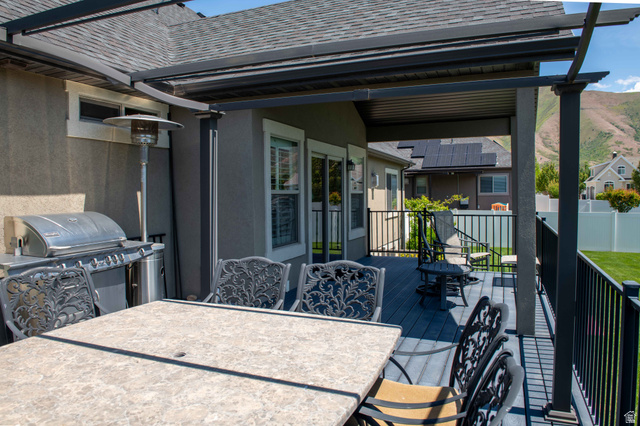 646 East 1400th Street North Mapleton, UT 84664 - Photo 72 of 78 Covered back deck featuring composite decking, black metal railings, and a solid roof pergola structure