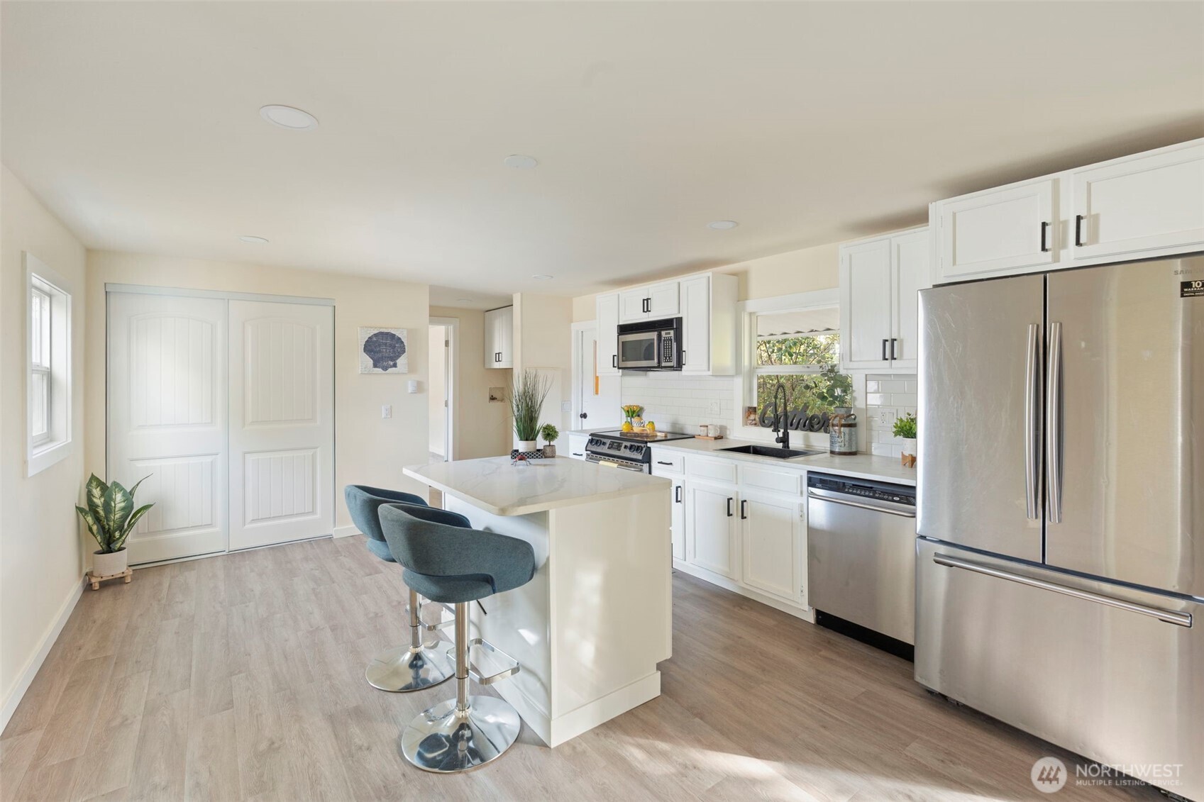 254 Ho Hum Lane Aberdeen, WA 98520 - Photo 7 of 27 a kitchen with kitchen island a counter top space a sink stainless steel appliances and cabinets