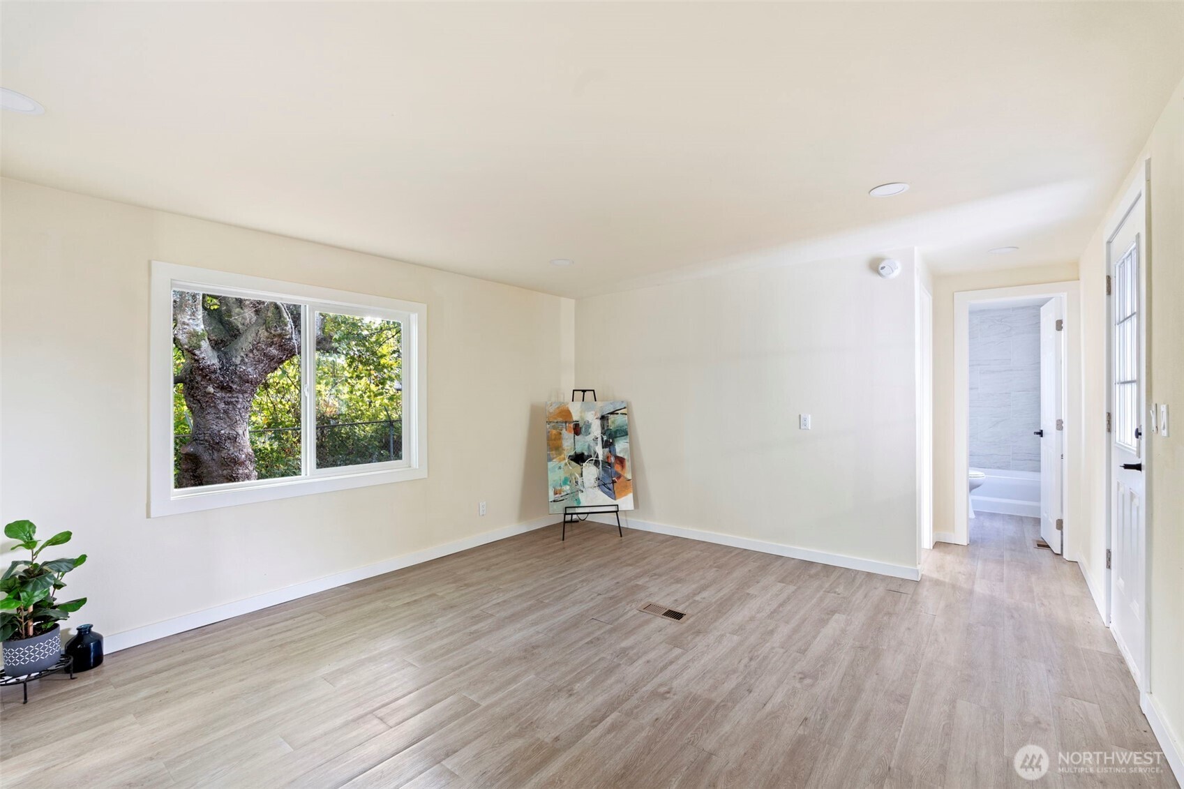 254 Ho Hum Lane Aberdeen, WA 98520 - Photo 9 of 27 an empty room with wooden floor and windows