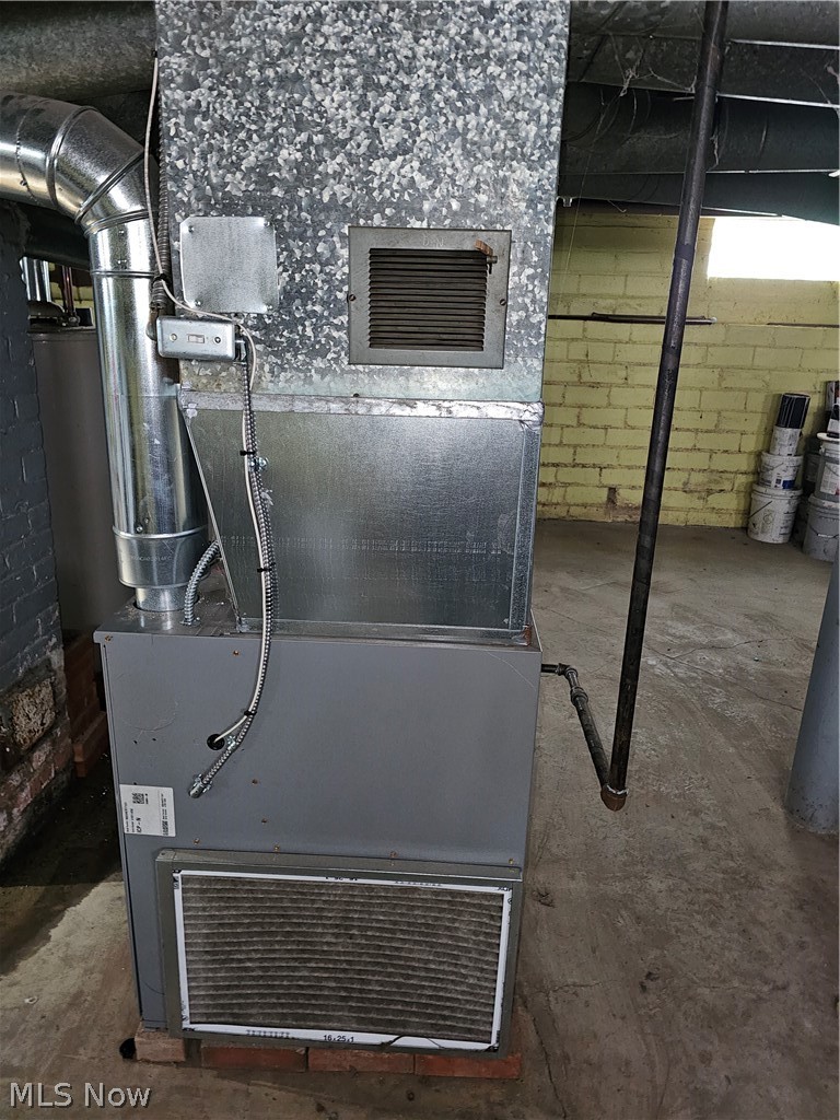 832 Hoover Road Cleveland, OH 44119 - Photo 10 of 10 Utility room featuring heating unit and water heater