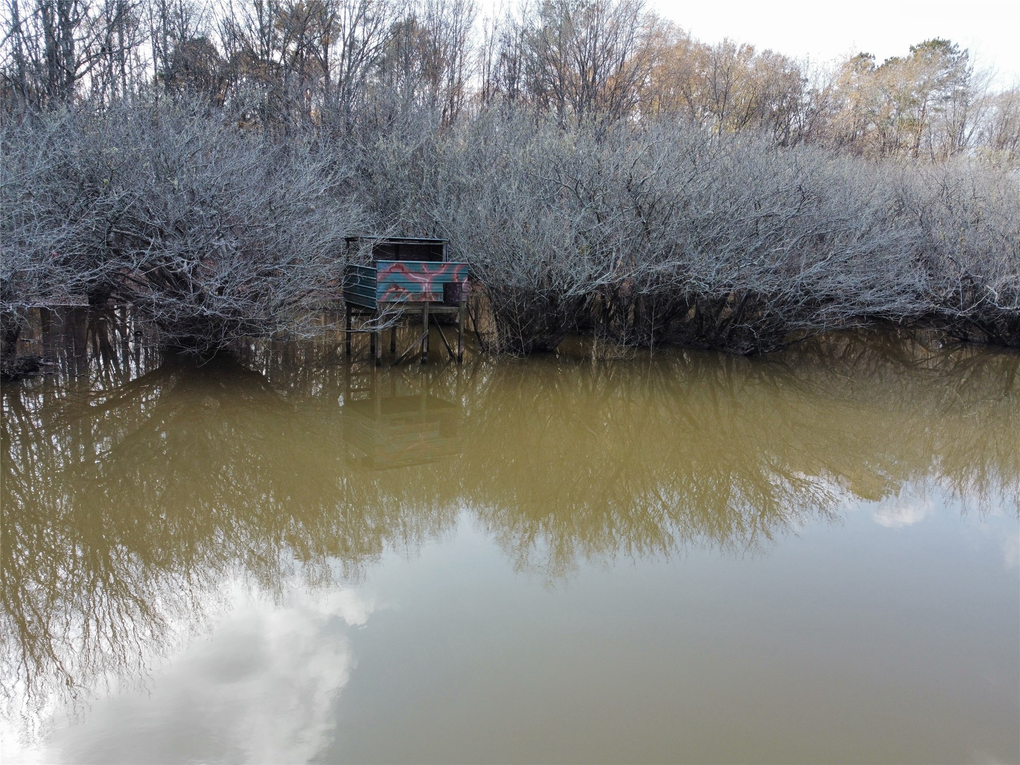 7525 East State Highway East Gilmer, TX 75645 - Photo 2 of 19 a view of a lake with a house in the background