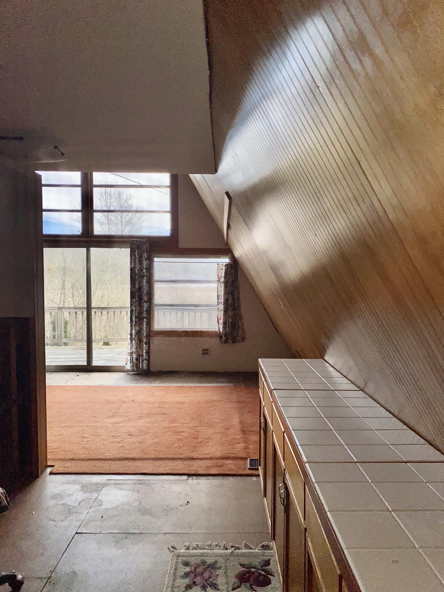 107 Peterson Road Becket, MA 01223 - Photo 11 of 34 a view of an empty room with windows