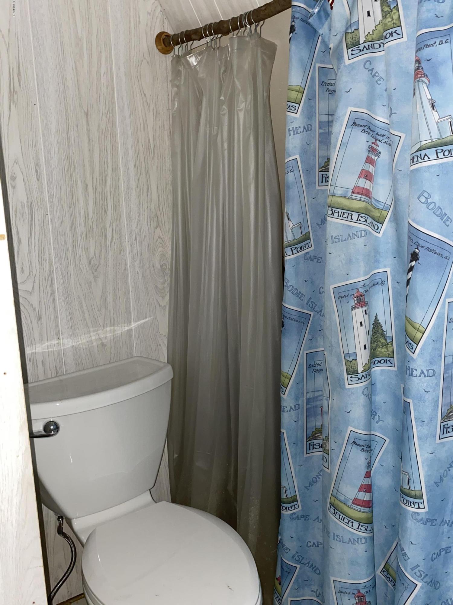 107 Peterson Road Becket, MA 01223 - Photo 13 of 34 a white toilet sitting next to a bath tub and shower