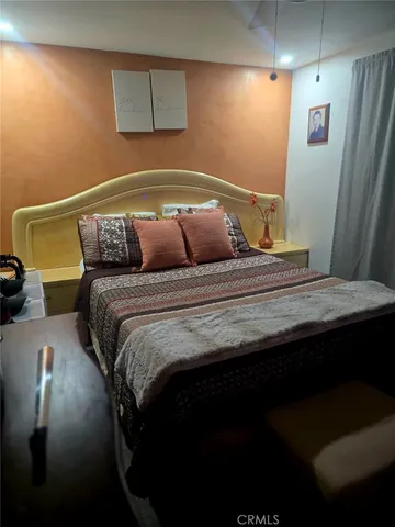 a bedroom with a bed and a chair
