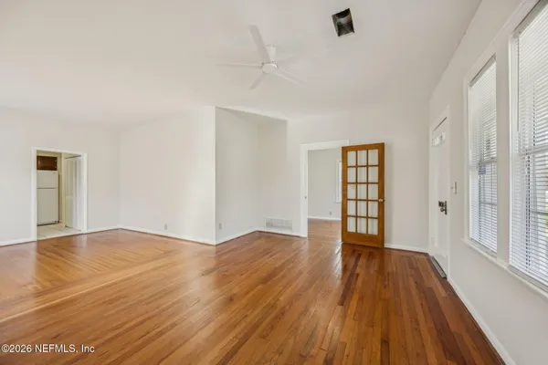 wooden floor in an empty room with a window