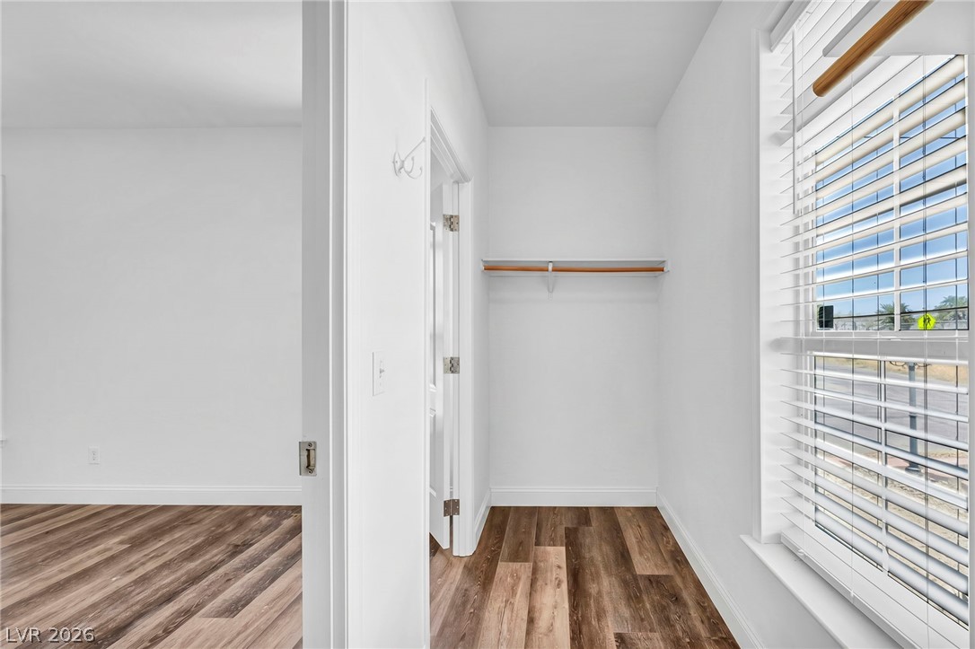 225 California Street Searchlight, NV 89046 - Photo 51 of 64 A deep walk-in closet with durable laminate flooring provides essential storage and organization.