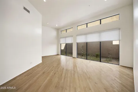 a view of empty room with wooden floor